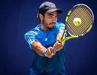 Young man playing tennis.