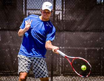 Teenager playing tennis.